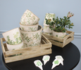 Set of two ceramic planters with vintage floral print in neutral tones, rustic handcrafted finish, and drainage holes.