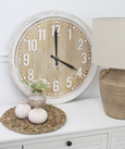 Hamptons-style round wall clock with whitewashed MDF frame, raised white numerals, and natural timber-look face, 60cm diameter.