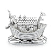 A silver-plated musical box figurine shaped like Noah's Ark, resting on stylized waves. Animals, including a lion, raccoon, and giraffes, are visible in the ark, with Noah hanging off the side. The overall finish is shiny silver.