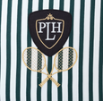 Paloma Tennis Stripes Cushion 55cm in green-and-white cotton stripes with embroidered tennis racquets and PLH crest motif. Close up of crest.