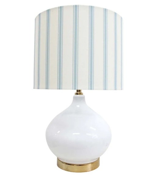 Bayville Lamp with rounded white glass base, gold detailing, and striped blue and white linen shade.