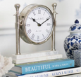 White Marble Round Column Clock sitting on stack of books