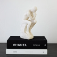 Thinking Man Statue on a stack of books