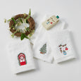 Set of three white cotton hand towels with embroidered Christmas motifs including ornaments, a Christmas tree, and a festive wreath window.