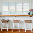 White Wood and Rattan Barstool at kitchen bench