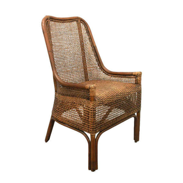 A natural brown rattan dining chair with a high, slightly curved backrest and armrests. The back and seat are both made from tightly woven rattan, and the chair has a classic, elegant silhouette.
