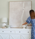 Bayville Lamp with rounded white glass base, gold detailing, and striped blue and white linen shade.