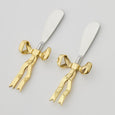 Bowtiful Spreaders Set of 2 with gold bow handles and stainless steel blades, perfect for entertaining and cheese platters.