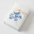 Chinoiserie Hand Towel Set of 2 featuring one plain white towel and one embroidered towel with a blue bird and floral design.