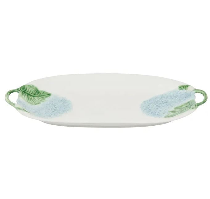 A ceramic platter with a blue hydrangea and green leaf pattern against a white background.