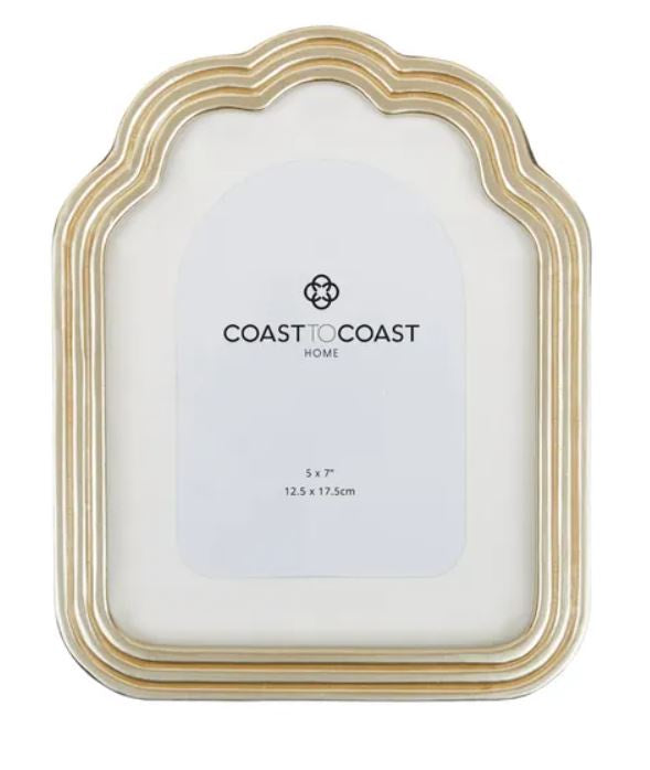 A gold-colored, resin picture frame with a wavy design, sized for a 5x7 photo