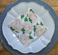 Demi Round Placemat Blue/White closeup with white plate and hydrangea napkin