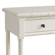 White Portico Console with bamboo-inspired accents, two drawers with brass pulls, and two lower shelves in an elegant coastal style design.
