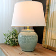 Avoca Seafoam Lamp with a handcrafted ceramic base in soft seafoam green, paired with a natural linen shade. A calming coastal-inspired table lamp perfect for Hamptons and contemporary interiors.