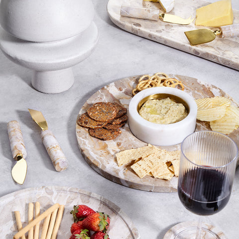 Marble bread and cheese boards styled with crackers, dips, cheese knives and wine for elegant coastal entertaining.