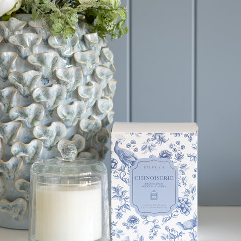 Chinoiserie fresh linen scented candle under glass cloche in Hamptons style interior
