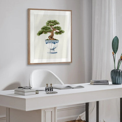 Framed botanical artwork featuring bonsai tree illustration styled above white console in a calm coastal interior
