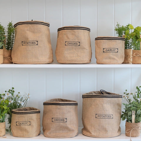 Hamptons Style best sellers featuring natural jute pantry sacks and kitchen storage styled on white shelving with greenery.