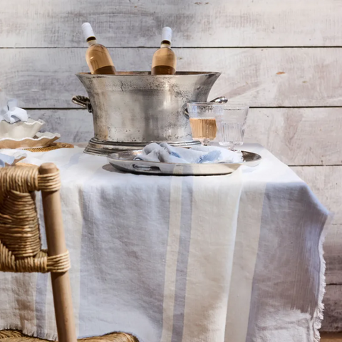 Hamptons style barware with champagne bucket, glassware and linen table styling in a coastal entertaining setting