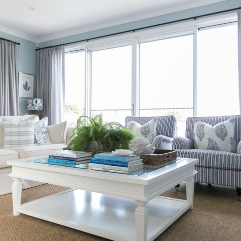Hamptons style living room with coastal coffee table books styled on a white timber coffee table