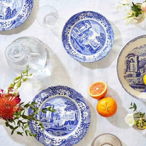 Blue and white Spode dinnerware beautifully styled on a coastal dining table with fresh flowers, citrus and elegant glassware.