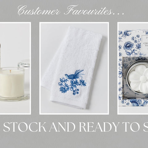 Customer favourites in stock and ready to ship, featuring a blue floral scented candle, embroidered white guest towel, and blue and white ceramic fragrance set.