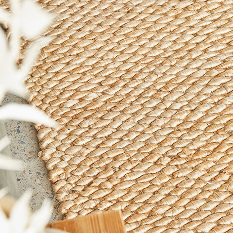 Natural jute rug with woven texture in a coastal Hamptons style interior