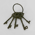 Set of five vintage-style cast iron keys on iron ring, brown patina finish