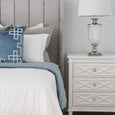 Allure Ocean blue velvet comforter styled on a bed with Palm Springs vintage blue cushions