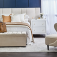 Ariana large white bedside table styled beside upholstered bed with layered décor