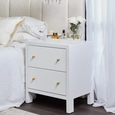 Ariana large white bedside table styled beside upholstered bed with layered décor