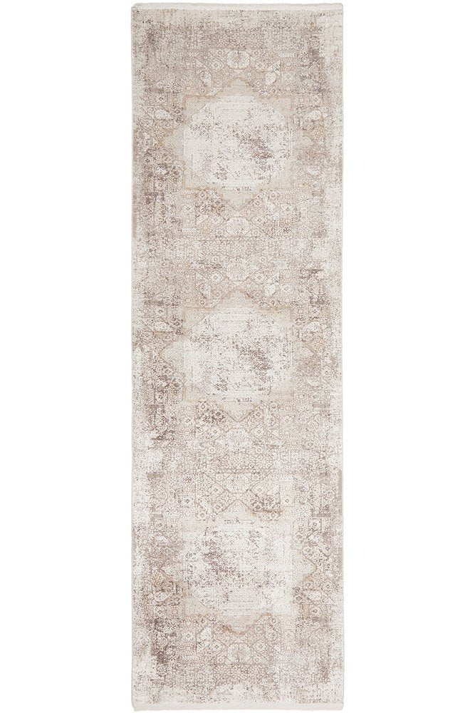 Arley Stone Runner with stone-toned distressed medallion pattern in neutral hues displayed in a hallway.