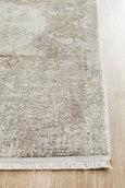 Arley Stone Runner with stone-toned distressed medallion pattern in neutral hues displayed in a hallway.