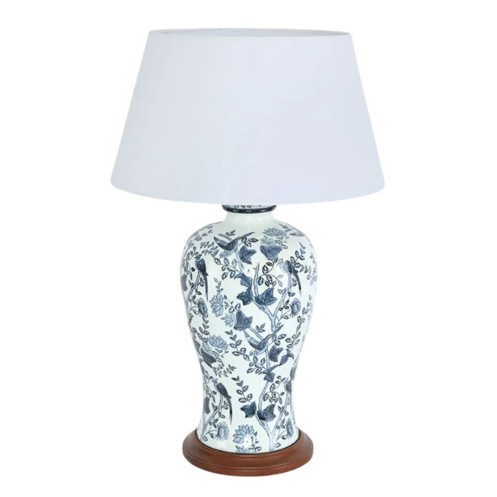 Blue and white ceramic table lamp with bird and floral pattern on wooden base and white shade