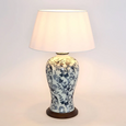 Blue and white ceramic table lamp with bird and floral pattern on wooden base and white shade