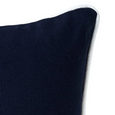 Navy lumbar cushion with white piping in heavy cotton canvas. Corner shown.