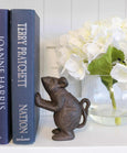 Cast iron decorative mouse doorstop or bookend named Basil, featuring a rustic brown finish and charming upright pose used as a bookend.