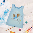 Beatrix Potter 47cm Peter Rabbit Children's Tabard flatlay with paints surrounding it
