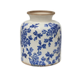 Blue and white stoneware floral vessel with vintage botanical pattern, shown on a white background
