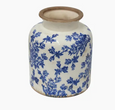 Blue and white stoneware floral vessel with vintage botanical pattern, shown on a white background