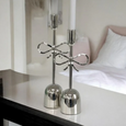 Pair of nickel bow candlesticks styled on a white mantel with classic interior detailing