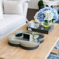 Bronzed clover mirror tray styled on timber coffee table in Hamptons living room