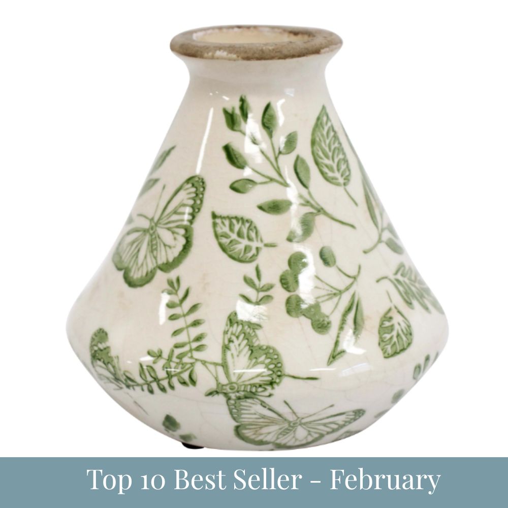 Small ceramic bud vase with green butterfly and foliage design on an off-white base, 12x12x12cm.