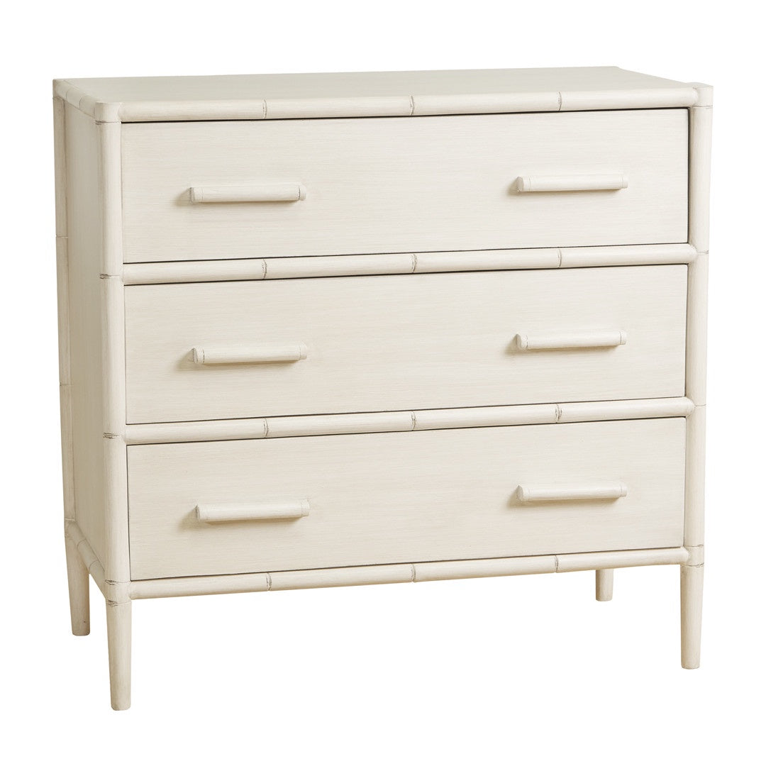 A chest of drawers with three full-width drawers. The frame and drawer faces are a distressed white wash colour, and the frame corners and drawer separators have subtle raised detailing that resembles bamboo poles. The drawers have long, recessed pull handles.
