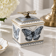 Butterfly Grey Trinket Box with blue-grey butterfly design, antique gold butterfly handle and crackle glaze, styled with hydrangeas and gold jewellery.