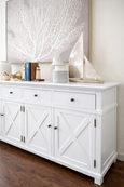 Side view of Canterbury satin white sideboard showing cross detail cabinetry and metal handles
