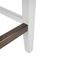 White timber stool legs with brass footrest detail