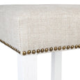 Close up of linen kitchen stool seat with bronze stud trim