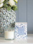 Chinoiserie glass cloche scented candle in French linen, styled on console with blue ceramic vase