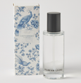 Chinoiserie French Linen scented linen spray in clear bottle with black cap beside blue and white floral patterned gift box.